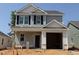 New two-story home featuring gray siding, black shutters, and an attached one-car garage at 251 Bluejay St, Clayton, NC 27520