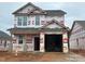 Two-story home under construction featuring an attached two-car garage and visible framing at 251 Bluejay St, Clayton, NC 27520