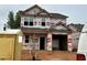 Under-construction two-story home featuring a two-car garage and framed window openings at 251 Bluejay St, Clayton, NC 27520