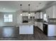 Bright kitchen features white cabinets, granite countertops, and stainless steel appliances at 251 Bluejay St, Clayton, NC 27520