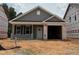 New construction exterior featuring gray siding, an attached garage and well-manicured lawn on a sunny day at 257 Bluejay St, Clayton, NC 27520