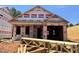 Image of a new construction home in the framing stage showcasing the exterior with a garage and Westan Homes branded house wrap at 257 Bluejay St, Clayton, NC 27520