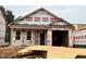 Under construction single Gathering home featuring a two-car garage and covered front entry at 257 Bluejay St, Clayton, NC 27520