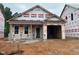 New construction home with a garage and covered entrance is set in a community at 257 Bluejay St, Clayton, NC 27520