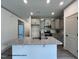Modern kitchen features gray cabinets, granite counters, stainless steel appliances, and a central island with a sink at 257 Bluejay St, Clayton, NC 27520