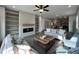 Cozy living room with built-in shelving, fireplace, modern ceiling fan, and comfortable seating arrangement at 257 Bluejay St, Clayton, NC 27520