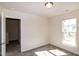 Bedroom with a sunlit window and open doorway featuring neutral walls and plush carpet at 261 White Oak Ridge Dr, Garner, NC 27529