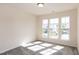 Well-lit bedroom with large windows and neutral carpet at 261 White Oak Ridge Dr, Garner, NC 27529