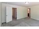 Spacious bedroom with carpet flooring and access to other rooms at 261 White Oak Ridge Dr, Garner, NC 27529