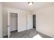 Bedroom with neutral walls and carpet featuring two open doorways and a closet at 261 White Oak Ridge Dr, Garner, NC 27529