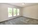 Bright bedroom features three windows and neutral carpeting at 261 White Oak Ridge Dr, Garner, NC 27529