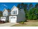 Attractive townhome with well-kept lawn, complemented by lush green trees at 261 White Oak Ridge Dr, Garner, NC 27529