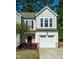 Beautiful townhome with a one-car garage, black shutters and a lovely green lawn at 261 White Oak Ridge Dr, Garner, NC 27529