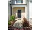 Inviting front entrance features a black front door and brick accents at 261 White Oak Ridge Dr, Garner, NC 27529