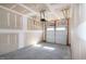 Spacious unfinished two-car garage with bare drywall, concrete floor, and an automatic door at 261 White Oak Ridge Dr, Garner, NC 27529