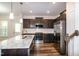 Modern kitchen featuring stainless steel appliances, granite countertops and dark wood cabinets at 261 White Oak Ridge Dr, Garner, NC 27529