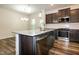 Open kitchen with island sink, stainless steel appliances, and wood flooring at 261 White Oak Ridge Dr, Garner, NC 27529