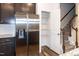Kitchen with stainless steel refrigerator, pantry, and staircase at 261 White Oak Ridge Dr, Garner, NC 27529