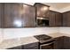 Kitchen cabinets with granite countertops, stainless steel appliances, and white subway tile backsplash at 261 White Oak Ridge Dr, Garner, NC 27529