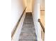 Carpeted stairway with a wooden handrail, leading to the upper level at 261 White Oak Ridge Dr, Garner, NC 27529