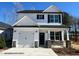 Charming two-story home with a one car garage, stone accents, and a covered front porch at 263 Bluejay St, Clayton, NC 27520