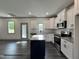 New kitchen features white cabinets, stainless appliances, and grey accent walls at 263 Bluejay St, Clayton, NC 27520