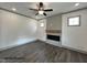 Cozy living room features an electric fireplace and ceiling fan at 263 Bluejay St, Clayton, NC 27520