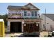New two-story home under construction with visible house wrap and two-car garage at 268 Bluejay St, Clayton, NC 27520