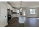Modern kitchen with granite countertops, stainless steel appliances, island and hardwood floors at 268 Bluejay St, Clayton, NC 27520