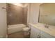 The bathroom showcases neutral toned tiled walls, a shower and tub, and a vanity with white cabinetry at 3020 Freewinds Way # 47, Cary, NC 27519