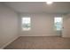 The bedroom offers neutral-toned walls, plush carpeting, and two windows that bring in ample natural light at 3020 Freewinds Way # 47, Cary, NC 27519