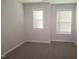 Simple bedroom featuring gray carpet and two windows at 3020 Freewinds Way # 47, Cary, NC 27519