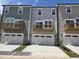A modern townhome exterior boasts attached garages, balconies, and neutral toned siding at 3020 Freewinds Way # 47, Cary, NC 27519