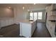 This bright, modern kitchen features a center island with stone countertops, stainless appliances, and ample cabinet space at 3020 Freewinds Way # 47, Cary, NC 27519