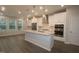 A modern kitchen features stainless appliances, white cabinetry, and a large center island with stone countertops at 3020 Freewinds Way # 47, Cary, NC 27519