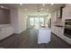 Open-concept kitchen showcasing a large island with white cabinets and modern stainless-steel appliances at 3020 Freewinds Way # 47, Cary, NC 27519