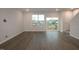 A bright living room offers stylish flooring, access to a wooden deck, and windows offering natural light at 3020 Freewinds Way # 47, Cary, NC 27519