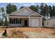 Charming single-story home with grey siding, a white garage door, and dark shutters at 31 Goldenrod Loop, Clayton, NC 27520