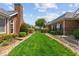 Beautiful backyard featuring a well-maintained lawn and thoughtfully designed landscaping at 312 Troon Village Ln, Cary, NC 27511