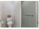 This bathroom has white tiling and a basket on the back of the toilet at 312 Troon Village Ln, Cary, NC 27511