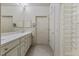 Bright bathroom with double sinks, closet, and tiled floors at 312 Troon Village Ln, Cary, NC 27511