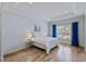 Bright bedroom with hardwood floors, tray ceiling, blue curtains, and neutral decor at 312 Troon Village Ln, Cary, NC 27511