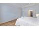 Bright bedroom with hardwood floors, tray ceiling, walk-in closet, and neutral decor at 312 Troon Village Ln, Cary, NC 27511