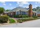 Charming brick home with manicured landscaping, mature trees, and well-maintained lawn creating an inviting curb appeal at 312 Troon Village Ln, Cary, NC 27511