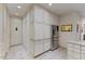 Kitchen area with stainless steel refrigerator and freezer, custom cabinets, and tiled floors at 312 Troon Village Ln, Cary, NC 27511
