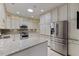 Modern kitchen featuring stainless steel appliances, granite countertops, custom cabinetry, and ample storage space at 312 Troon Village Ln, Cary, NC 27511
