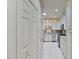 Long kitchen features white cabinetry, granite countertops, stainless steel appliances, and tiled floors at 312 Troon Village Ln, Cary, NC 27511