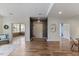 Open-concept area with hardwood floors, and natural light from sunroom entrance at 312 Troon Village Ln, Cary, NC 27511