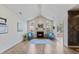 Light-filled living room featuring a fireplace, hardwood floors, and arched windows with cozy seating and decor at 312 Troon Village Ln, Cary, NC 27511