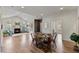 Spacious living area with a fireplace, dining table, and views of the outdoor scenery through arched windows at 312 Troon Village Ln, Cary, NC 27511